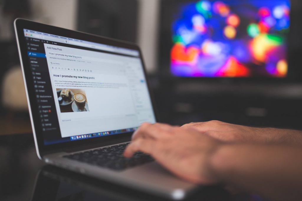 Blogger blogging on laptop using wordpress