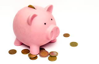 piggy bank with coins scattered around