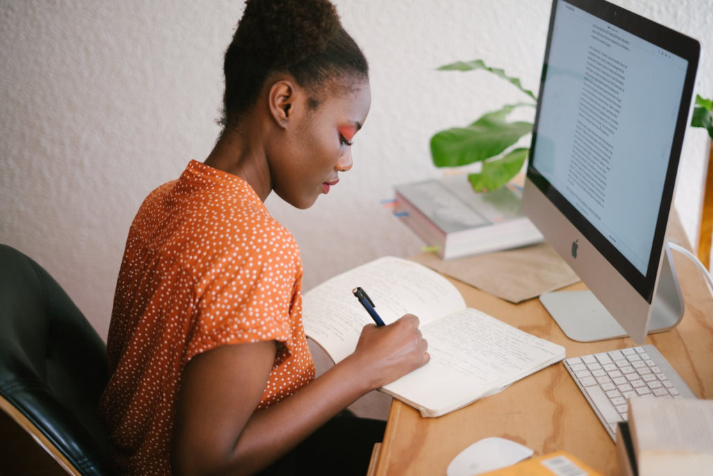 Woman working at a computer desk planning a career change