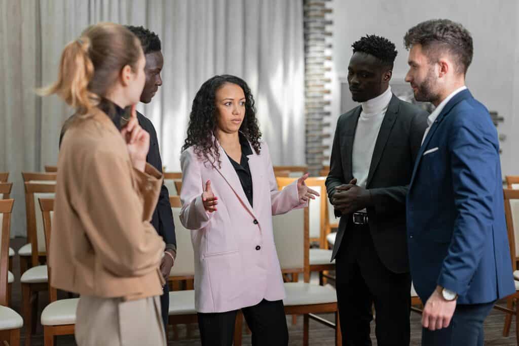 a woman explaining something to a group of people